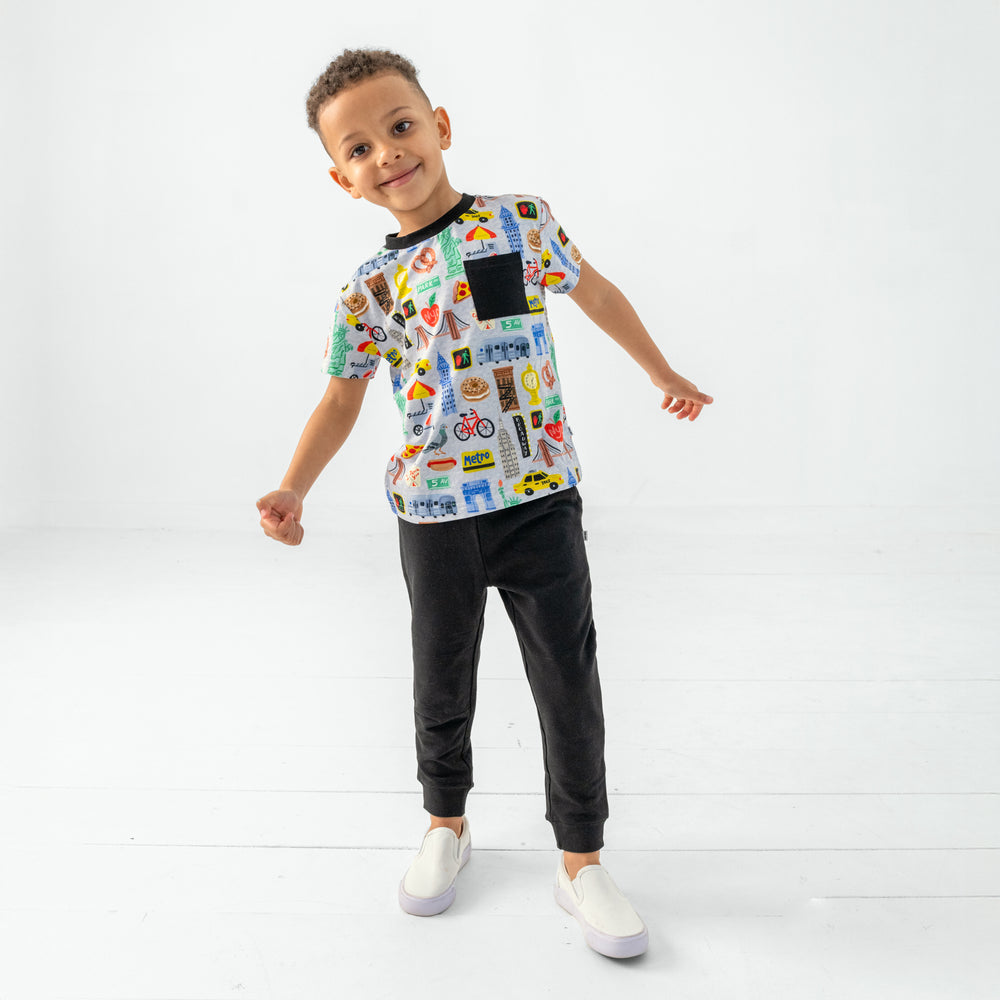 Standing child wearing the The Big Apple Relaxed Pocket Tee