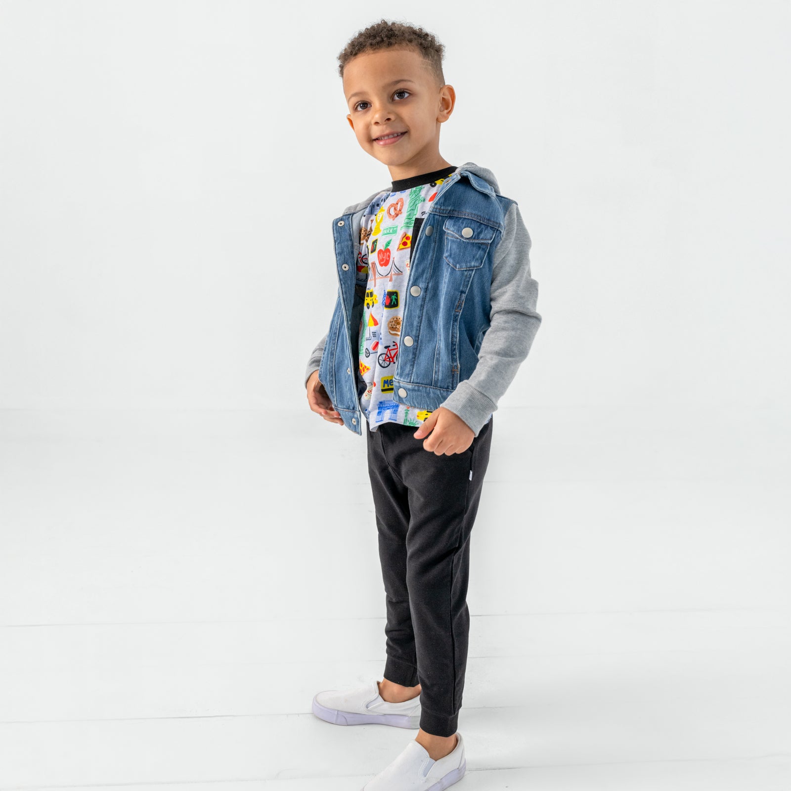 Standing child wearing the The Big Apple Relaxed Pocket Tee with black bamboo joggers