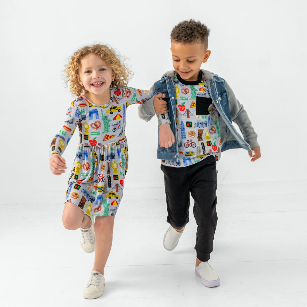 Two children wearing matching The Big Apple styles
