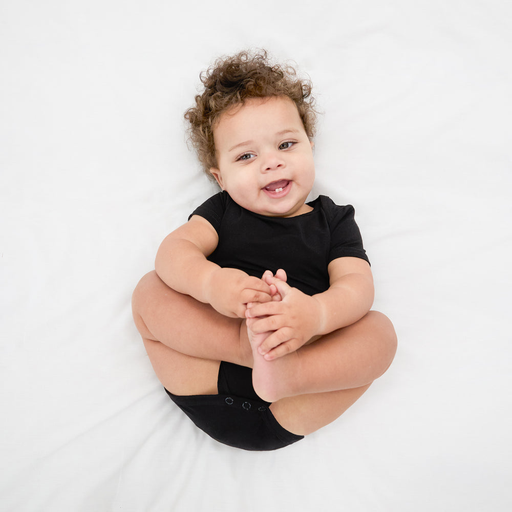 Ariel view of child wearing the Black Bodysuit