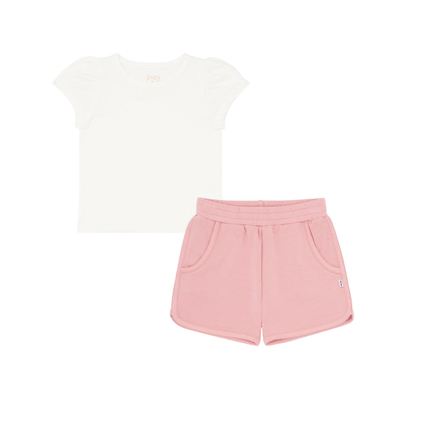 flat lay composite of a soft white puff sleeve tee and mauve blush dolphin shorts