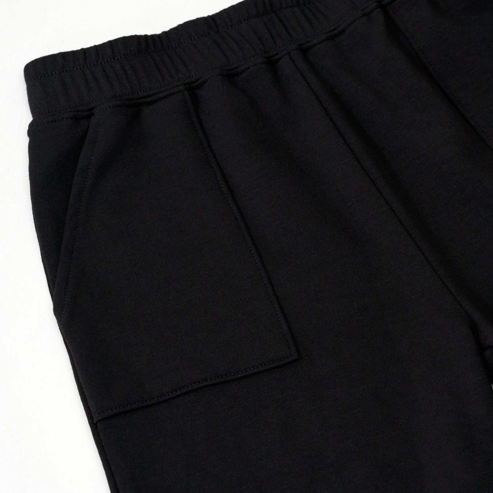 Flat lay image of the pocket detail on the Black Play Shorts