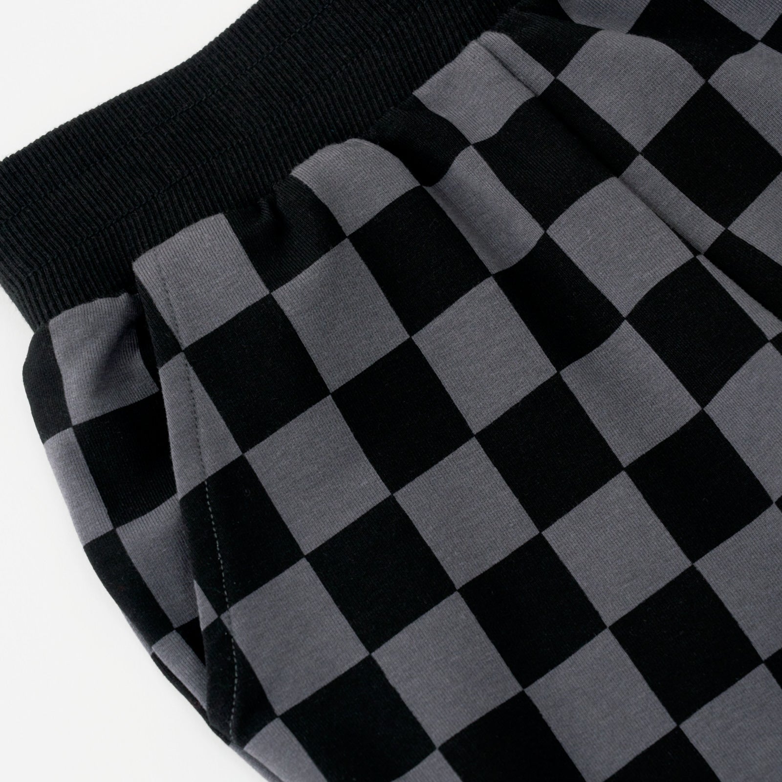 Close up flat lay image of the waist and pocket detail on the Monochrome Checks Joggers
