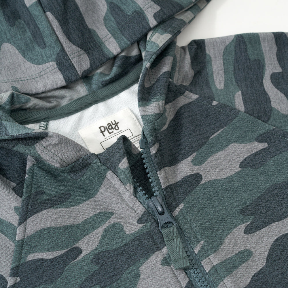 Close up flat lay image of the collar and zipper detail on the Vintage Camo Zip Hoodie