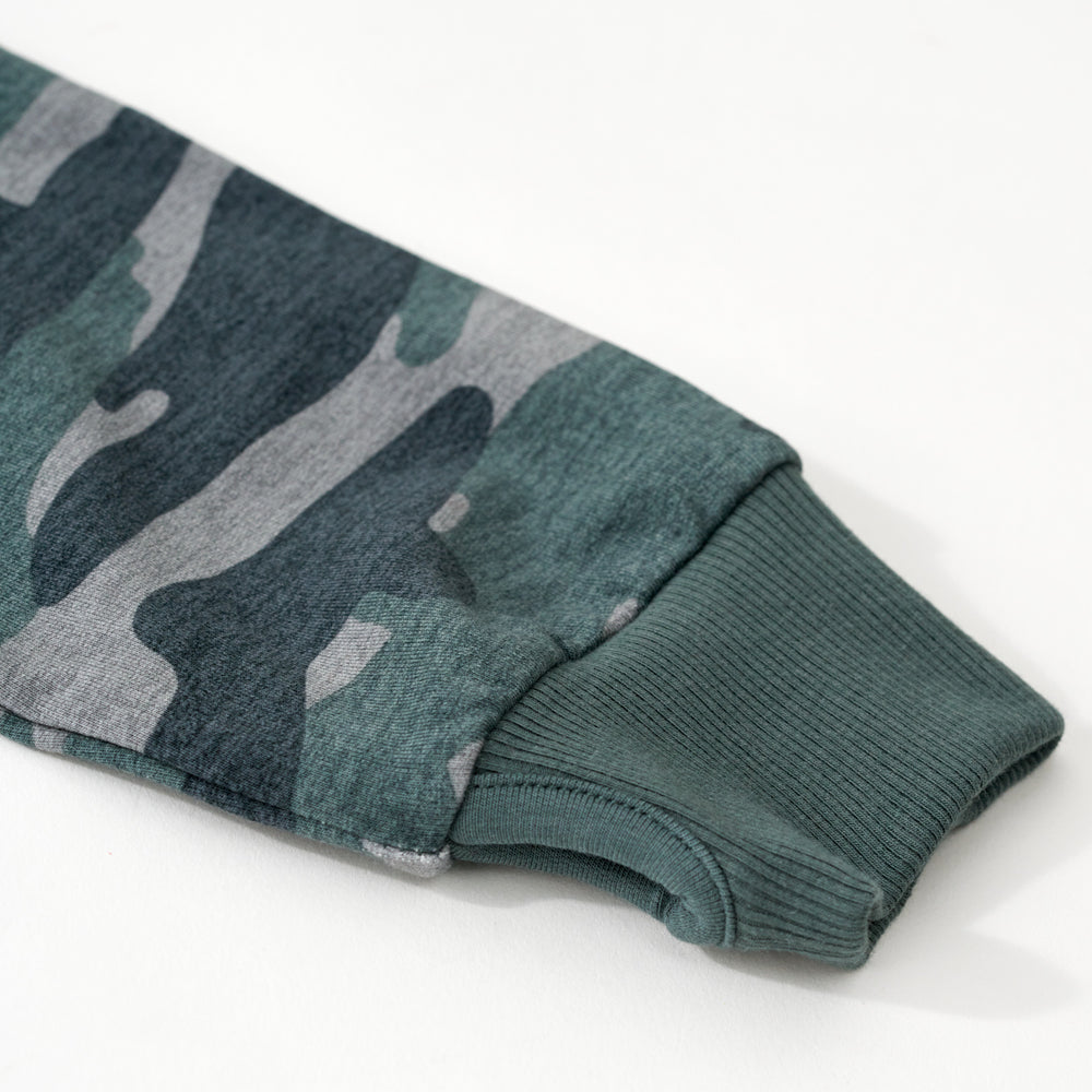Close up flat lay image of the sleeve and thumb hole detail on the Vintage Camo Zip Hoodie