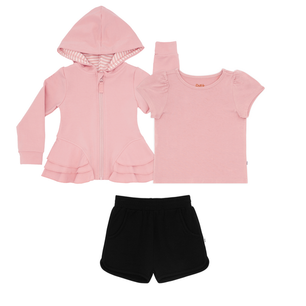 flat lay composite of a mauve blush peplum hoodie, puff sleeve tee, and black dolphin shorts