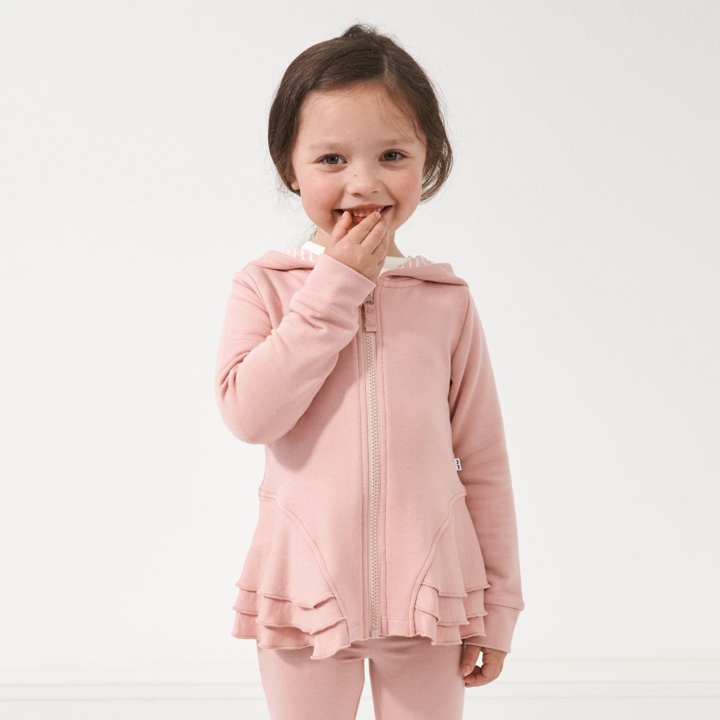 Child wearing a Mauve Blush peplum hoodie